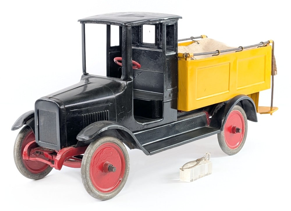 Buddy L Ice Delivery Truck: Buddy L Ice Delivery truck. The truck has an old overpaint with dents, pitting, and age wear showing. The truck comes with a pair of reproduction tongues and pieces of ice. A good restoration candidat