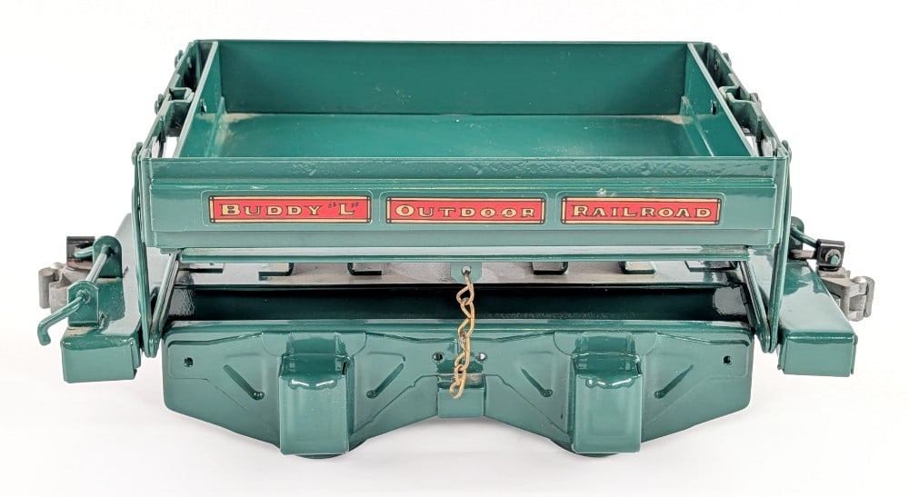 T-Reproductions Buddy L Outdoor Railroad Side Dump Car: T-Reproductions Buddy L Outdoor Railroad side dump car. The bed dumps from each side, but can be chained down to keep it stabilized. Excellent condition. Measures approximately 12" long.