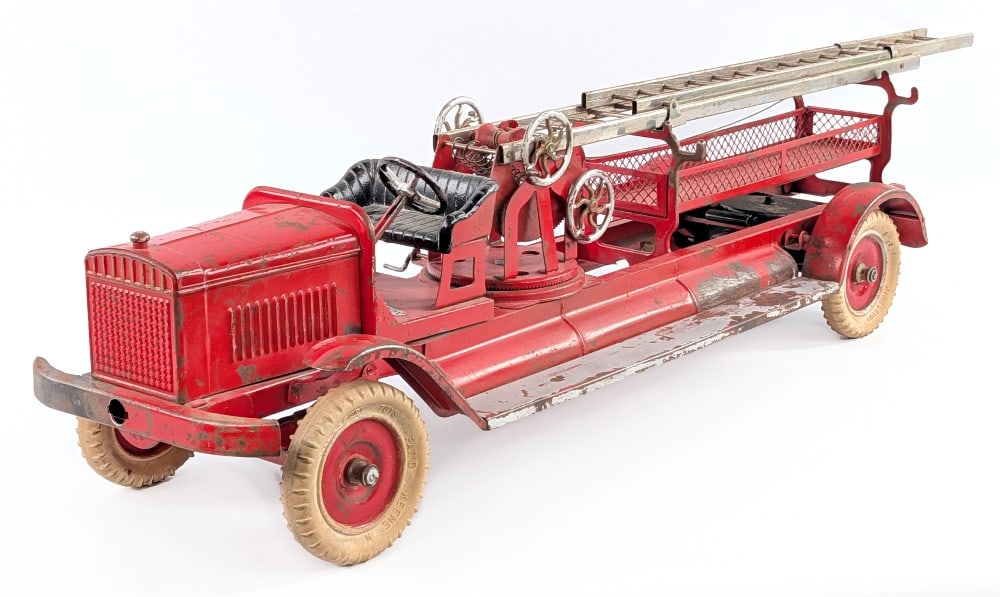 Kingsbury Little Jim Aerial Ladder Fire Truck: Kingsbury Little Jim aerial ladder fire truck. Rear wheels have a windup mechanism that works, but is missing the key. The truck is missing the extension ladders. Little Jim Playthings decal located b