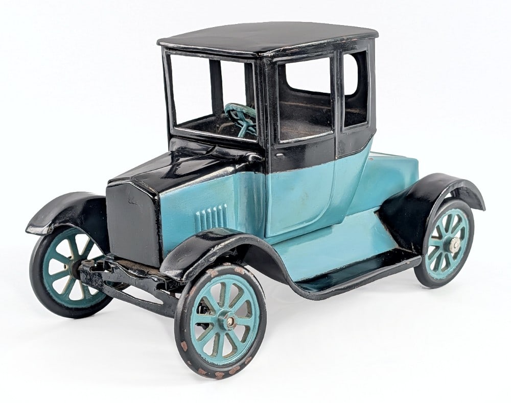 Buddy L Flivver Coupe: Repainted Buddy L Flivver coupe. An old custom repaint. The driver side front wheel is loose. It shows some paint loss and wear from age. Measures approximatley 11" long. *From the Gene Griser Collect