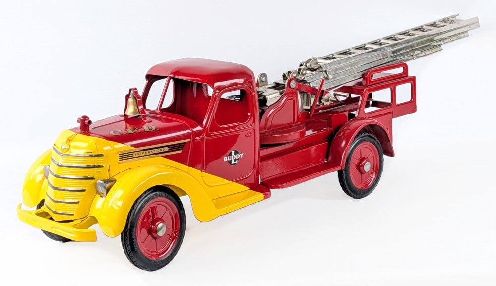 Restored 1938 Buddy L International Aerial Ladder Fire Truck: Restored 1938 Buddy L International aerial ladder fire truck. The truck has a very nice professional restoration. Excellent condition with minor dust from display. Comes without the steering handle an