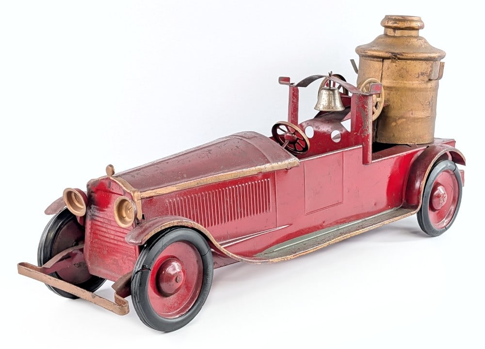 Turner Packard Fire Pumper Truck: Turner Packard fire pumper truck. The truck has a working friction drive motor on the rear. It is missing the ladders and some of the tires show glue repairs. Original condition with paint loss and we