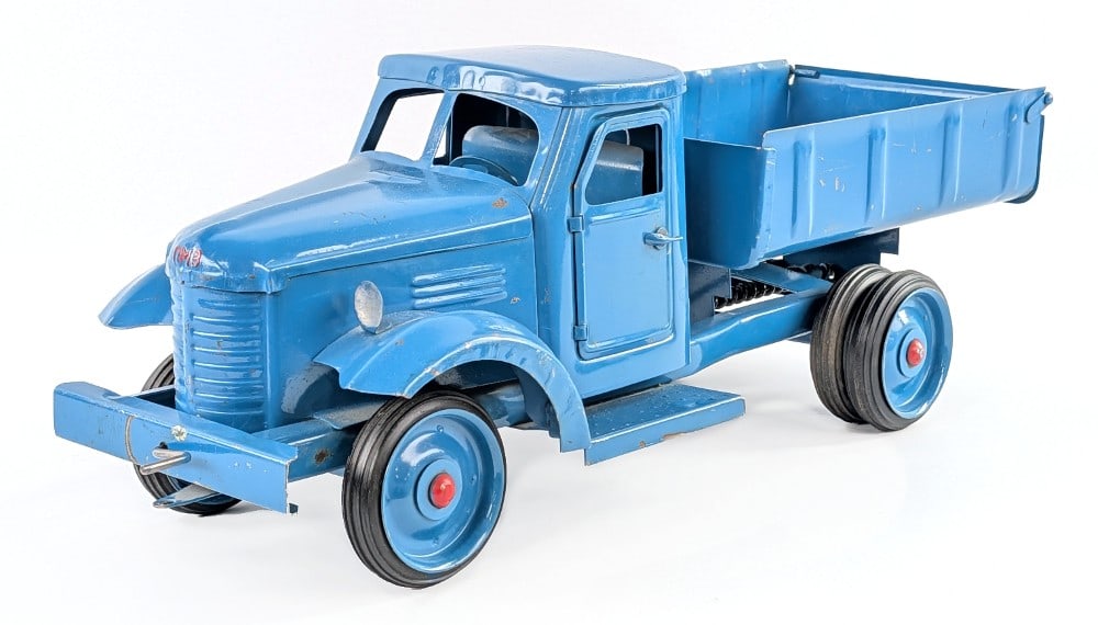 Russian Dump Truck: Painted pressed steel dump truck. Made in Russia. The truck features opening doors and crank style dump bed. The truck shows some scratches, paint loss and wear from age. Measures approximately 21" lo