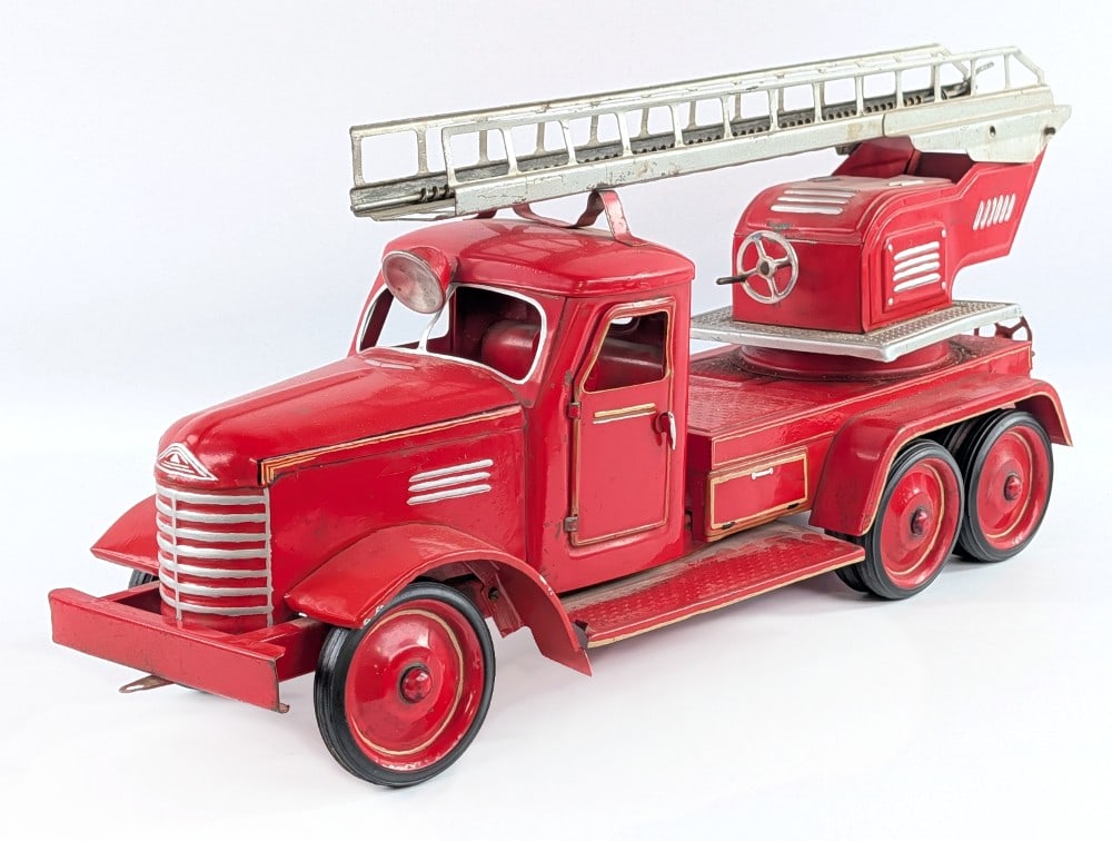 Russian Fire Truck: Russian fire truck. The truck has some old repaint, paint loss, and wear from play and age. The doors on the cab open. The ladder needs some attention in order for it to work. Measures approximately 2