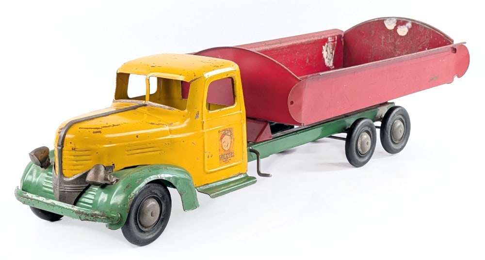 Turner Dump Truck: Turner dump truck. The truck is original, but does have some white paint splatter in the bed. The truck shows some paint loss and wear from play / age. Measures approximately 27" long. *From the Gene 