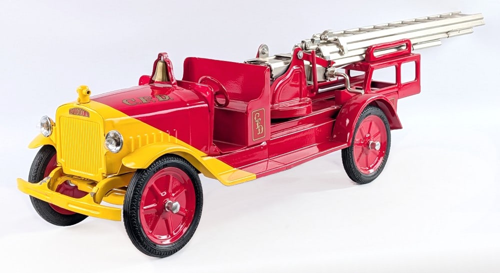 Restored Buddy L International Aerial Ladder Fire Truck: Restored Buddy L ride on aerial ladder fire truck. The truck is missing the steering handle and the seat. The ladder works as it should. The truck has electric headlights. It does have some paint loss