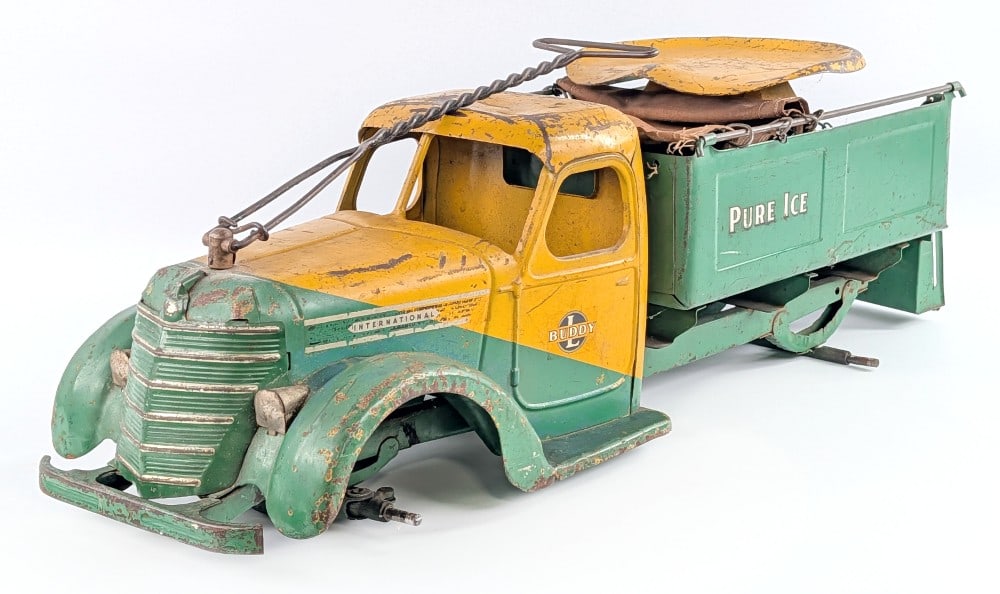 1938 Buddy L International Pure Ice Truck: 1938 Buddy L International Pure Ice truck. The truck is missing the wheels, but otherwise appears to be complete. The truck has a dent on the roof of the cab, paint loss, and wear from age. Overall a 