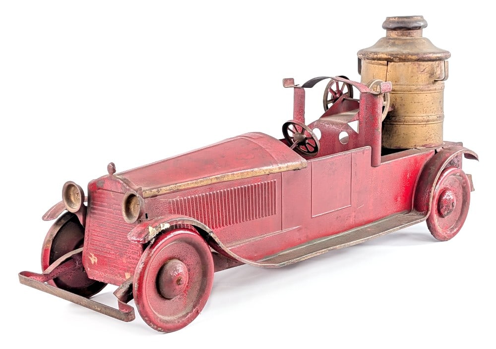 Turner Packard Fire Pumper Truck: Turner Packard fire pumper truck with friction drive. The truck is missing the ladders and tires. The truck has alligatoring to the paint, paint loss, and wear from play and age. Measures approximatel