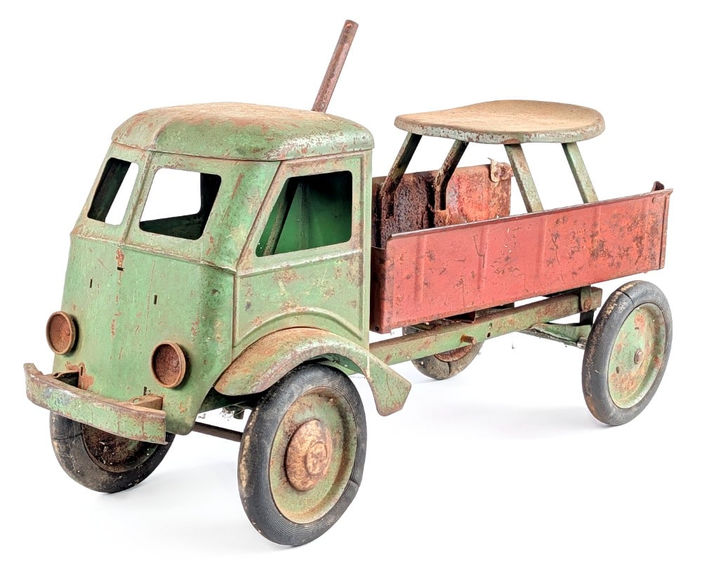 Keystone Ride 'Em Dump Truck: Keystone Ride 'Em dump truck. The truck is missing the steering handle, grill, hubcaps, and rear tailgate. It shows rust, paint loss, and age wear. Sells as is. It would make for a great custom projec