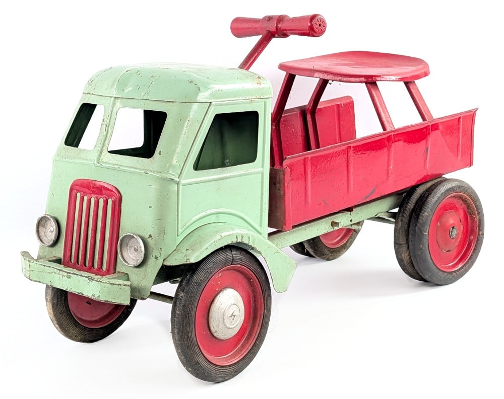 Keystone Ride 'Em Dump Truck: Keystone Ride 'Em dump truck. The truck has an old overpaint. It is missing the rear tailgate and one of the hubcaps. The truck shows paint loss and wear from age. A good restoration or custom project