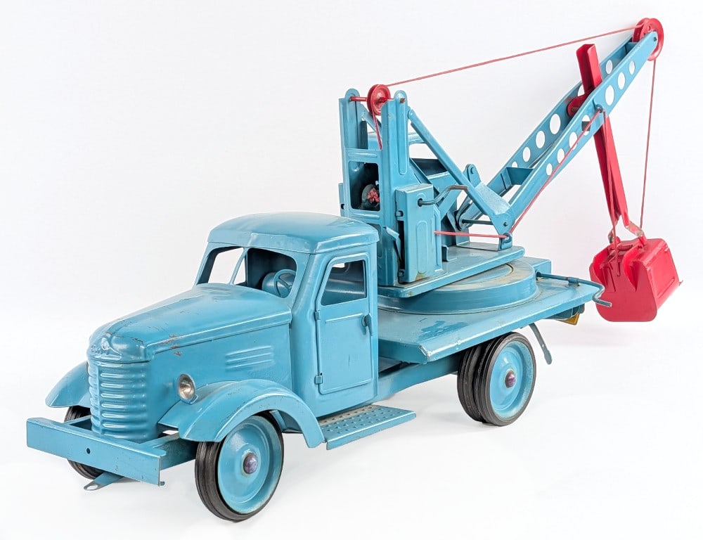 Russian Steam Shovel Truck: Russian steam shovel truck. The truck has an older overpaint with some paint loss and age wear showing. The cranks for the steam shovel bucket work. Measures approximately 31" long *From the Gene Gris