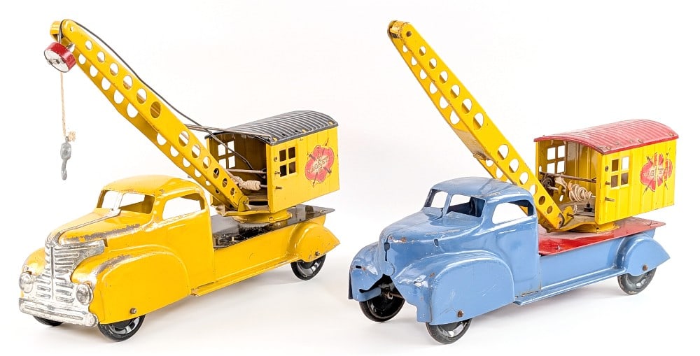 Marx Magnetic Crane Trucks: Marx magnetic crane trucks. The blue truck is for parts as it is missing the grill, wires for the boom, rear door on the crane, and magnet. The yellow truck appears to be complete. Both show paint los