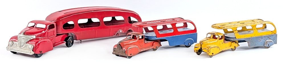 Marx Car Carrier Auto Hauler Trucks: Marx car carrier / auto hauler trucks. The yellow truck is missing the grill. No cars included. The trucks show paint loss and wear from play / age. The larger red trailer is missing the wheels. Large