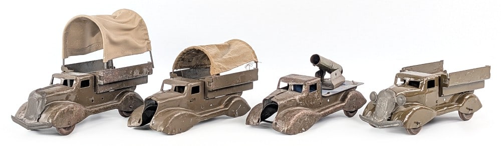 (4) Marx Military Vehicles: (4) Marx military vehicles. Two of the trucks are missing the grills, some are missing wheels, the one has a replacement canvas. Sells as is. Each measure approximately 10" long.? *From the Gene Grise