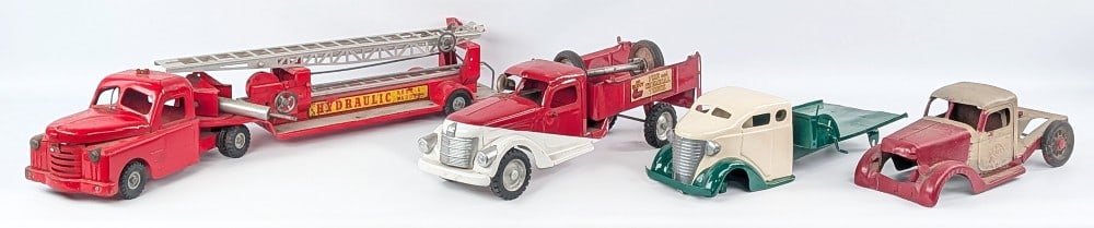 Buddy L, Structo, and Turner Truck Parts: Includes Buddy L fire and chemical truck, Buddy L International cab, Turner flatbed truck, and Structo aerial ladder truck. The trucks are missing parts or in need of restoration. The structo ladder t