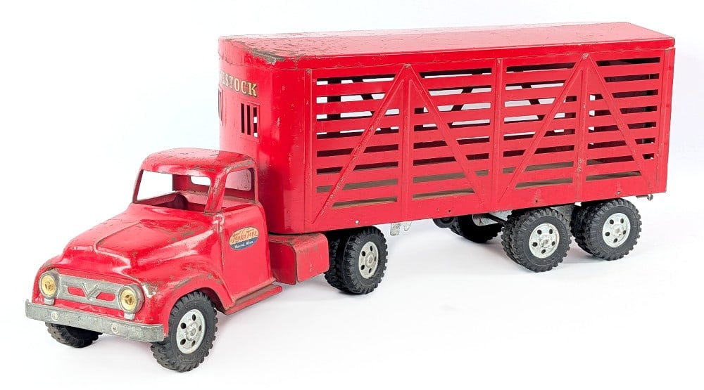 Tonka Livestock Truck & Trailer: Tonka livestock truck and trailer. The hitch on the trailer was replaced with a nut and bolt. The trailer is missing the mudflaps. The truck shows paint loss, surface rust, and wear from play and
