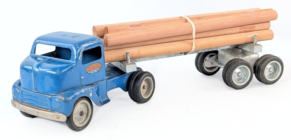 Tonka Log Hauler Truck: Tonka log hauler truck and trailer. The logs are replacements. The truck shows paint loss, and wear from play and age. Measures approximately 22" long. *From the Gene Griser Collection*