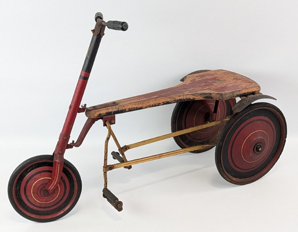 1920's The Famous Flivver Ride On Tricycle: 1920's The Famous Flivver child's ride on tricycle toy. The Flivver features original paint and patina. Showing wear from use and age, but overall displays very well. An unusual early child's ride on 