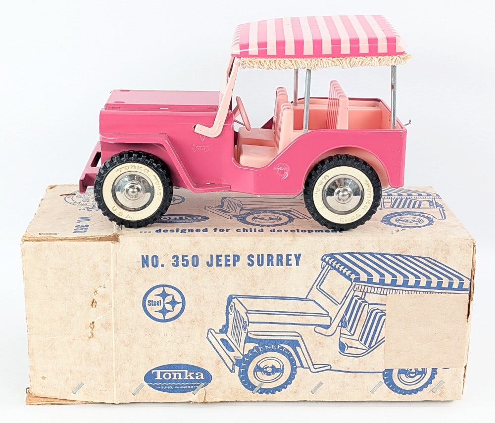 Tonka No. 350 Pink Jeep Surrey with Box: Original Tonka No. 350 pink Jeep Surrey with the original box. The Jeep is missing one of the metal posts and has a crack by the rear seat. The canopy on the Jeep has chips in the plastic where the po