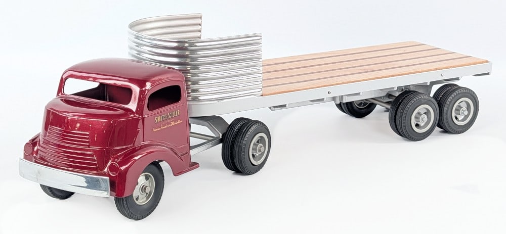 Custom Smith Miller GMC Truck with Flatbed Trailer: Custom Smith Miller GMC truck with flatbed trailer. A very nice high quality custom. It features a new wood deck and custom painted cab. Very good condition. Measures approximately 23" long.