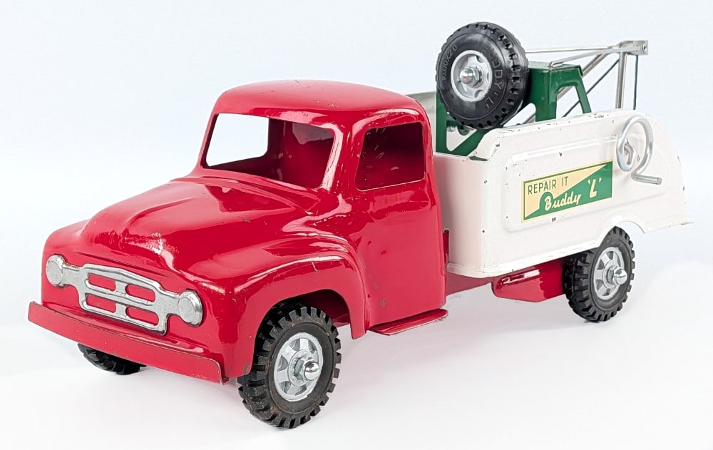 Original Buddy L Repair-It Wrecker Tow Truck: Original Buddy L Repair It wrecker tow truck. The truck shows some scattered paint chips and light wear from play / age. Measures approximately 16" long.