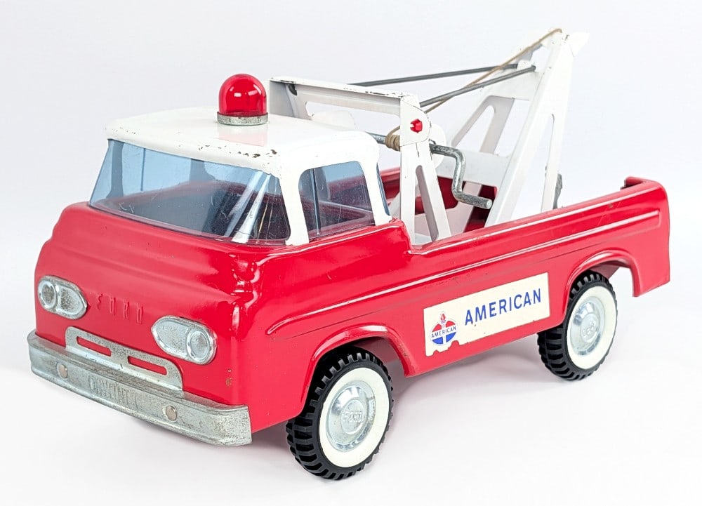 Original Nylint Ford American Emergency Unit Tow Truck: Original Nylint Ford American Emergency Unit wrecker tow truck. The truck has some light play wear including some paint loss, and minor loss to the American decals. Displays well overall. Measures app