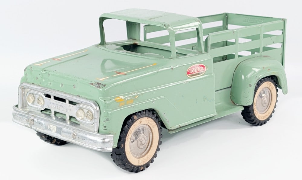 Tonka Stake Bed Truck: Tonka stake bed truck. The truck is missing the front stake between the cab and the bed. It is also missing the windshield. The truck has period custom decals on the hood and front fenders. The truck 
