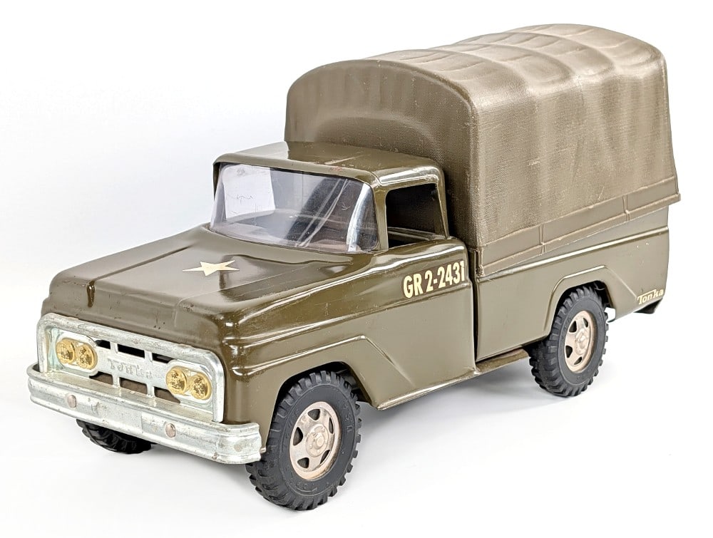 Original Tonka Army Troop Carrier Truck: Original Tonka army troop carrier truck. The truck is missing the plastic benches that go in the bed of the truck. The truck has some scratches and minor play wear. Measures approximately 14" long.