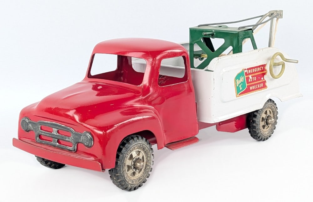 Original Buddy L Emergency Auto Wrecker Tow Truck: Original Buddy L Emergency Auto Wrecker tow truck. The truck is missing the spare tire and the string / cable has been replaced. The truck shows paint loss and play wear. Measures approximatley 15" lo