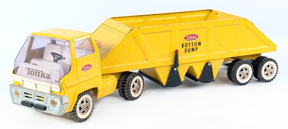 Original Tonka Gas Turbine Truck w/ Bottom Dump Trailer: Original Tonka gas turbine truck with bottom dump trailer. The truck and trailer show paint loss, scratches, and light play wear. Measures approximately 25" long.