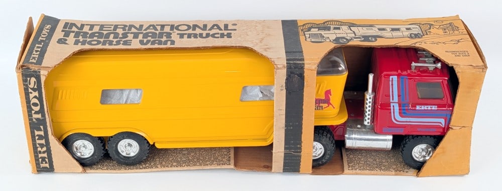 Ertl International Transtar Truck & Horse Van in Box: Ertl International Transtar truck with horse van trailer. Very good condition in the box with the horses. The box shows staining and wear from handling / storage. Measures approximately 23" long