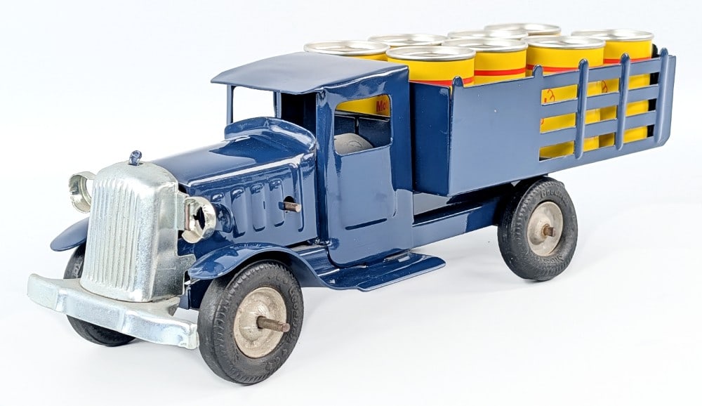 Custom Metalcraft Shell Oil Delivery Stake Truck: Custom Metalcraft Shell oil delivery stake truck with Shell oil barrels. Good condition with a nice paint job and new oil barrels. No bulbs for the headlights. Measures approximately 12-1/2" long.