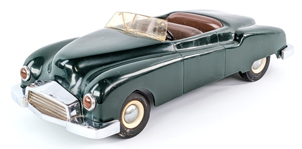 Vintage Steer-O-Toys Convertible Car: Vintage Steer-O-Toys convertible car. The car has a cracked windshield, but otherwise is in good condition with wear from age. Made of mostly plastic with some metal parts. Measures approximately 13" 