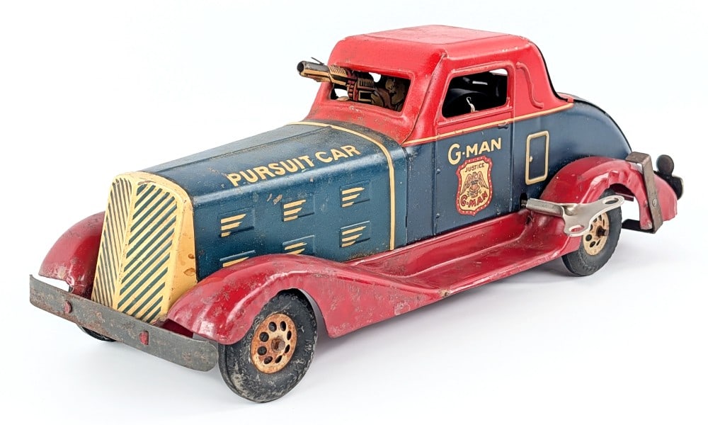 Marx Windup G-Man Pursuit Car: Marx windup G-Man Pursuit Car. The windup mechanism works and makes a popping gun like sound. The key is a replacement. It still has the original rear license plate and taillight. Original condition s