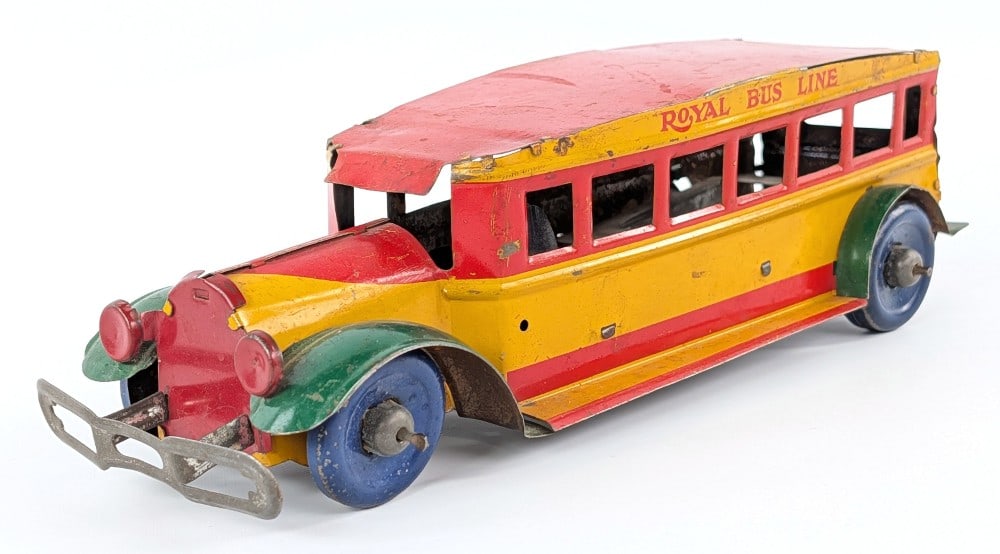 Marx Tin Royal Bus Line: Marx tin Royal Bus Line bus. The bus is missing the mounted spare tire and the windup mechanism. It has scratches and wear from play and age. Measures approximatley 10" long.