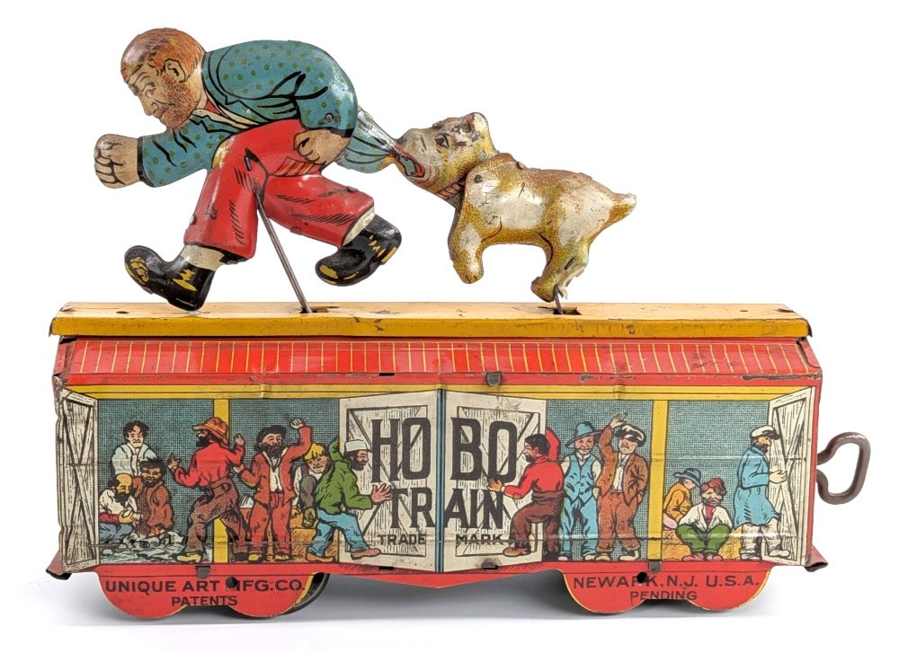 Unique Art Tin Windup Hobo Train: Unique Art tin litho windup Hobo Train. The windup mechanism works showing a hobo on the top of the train car and his shirt being pulled by a dog. Showing typical wear from age. Displays very well wit