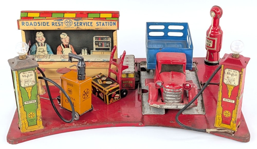 Marx Roadside Rest Service Station: Marx Roadside Rest Service Station. Comes with a foreign tin truck, Marx lubester, and dolly. Displays well with great graphics. Showing some paint crazing and loss from age. Measures approximately