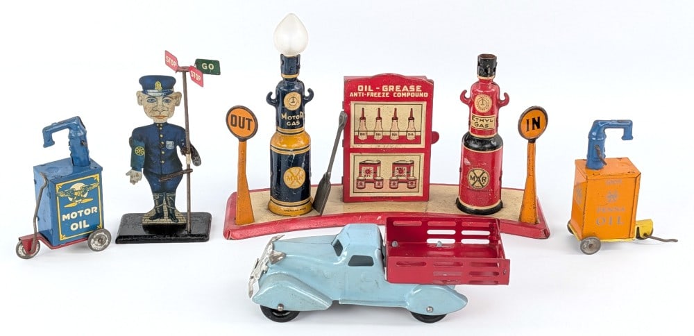 Marx Traffic Cop, Gas Station, Stake Truck, and Lubesters: Early Marx tin animated Traffic Cop, Gas Station, stake bed truck, and lubesters. The traffic cop has a revolving Stop n Go signs. It is missing one of the "GO" signs. The gas station island display c