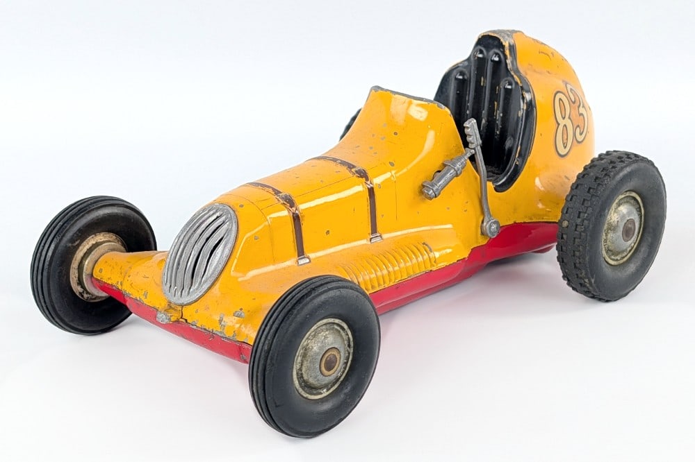 Roy Cox Thimble Drome Champion #83 Racer - Yellow: Original Roy Cox Thimble Drome Champion #83 race car in yellow. The car has some paint loss and wear from play and age. Measures approximately 9-1/2" long.