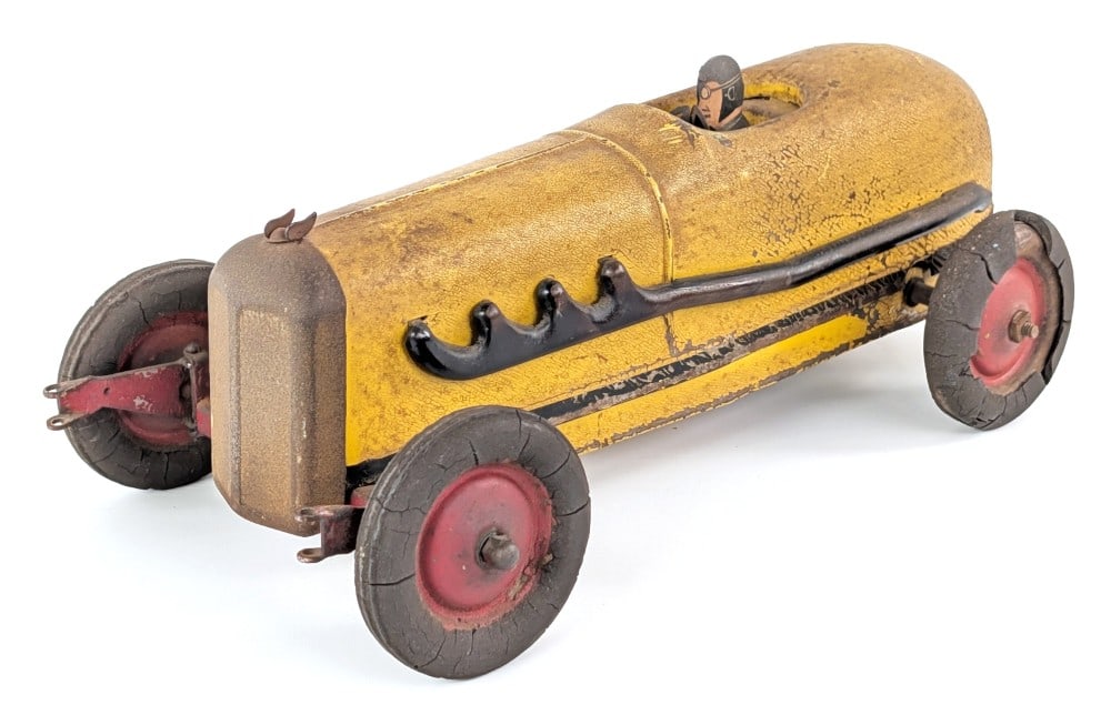Kokomo Electricar Yellow Racer: Original Kokomo Electricar yellow racer. The front wheels spin freely as its missing the bar. The car has cracks in the tires, paint flaking, and wear from use and age. Displays well with great patina