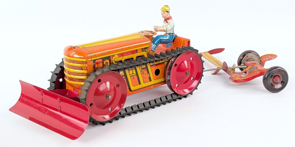 Marx Tin Windup Crawler Bulldozer & Sickle Mower: Marx tin litho windup crawler with blade and sickle bar mower. The windup mechanism works on the crawler. The sickle bar moves when the toy is pulled. Displays well with great graphics. Measures appro