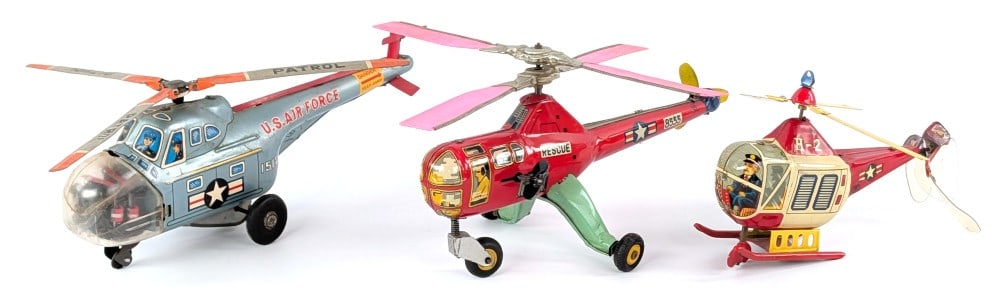 Japan Tin Friction & Windup Helicopters: (3) Japan tin friction and windup helicopters. Includes a TN Japan U.S. Air Force Patrol helicopter, Modern Toys Japan windup H-2 helicopter, and a Japan windup rescue helicopter. All are in working c