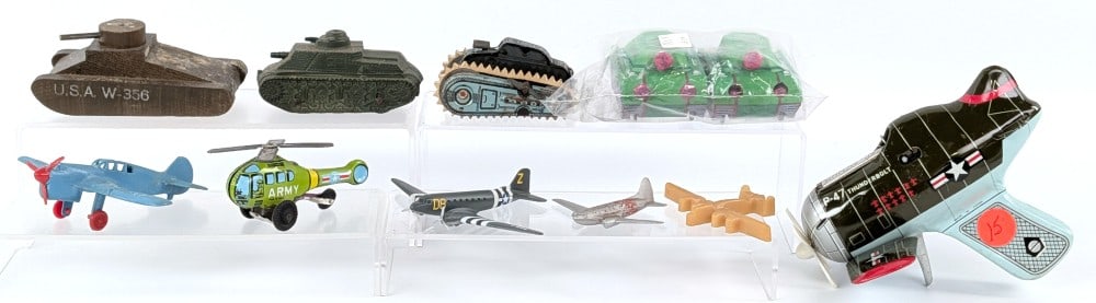 Military Tanks and Airplane Toys: Includes a P-47 Thunderbolt cap action airplane, army helicopter, firework tanks, airplane toys, and other tank toys. Some items showing wear from play or age. largest measures 6" across.?