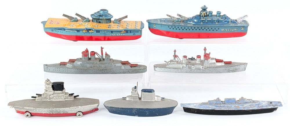 Vintage Tin and Die-Cast Ships: Includes vintage tin, die-cast, lead, and one plastic aircraft carriers and battleships. All are in good condition with minor play wear. Largest measures 6-1/4" long.