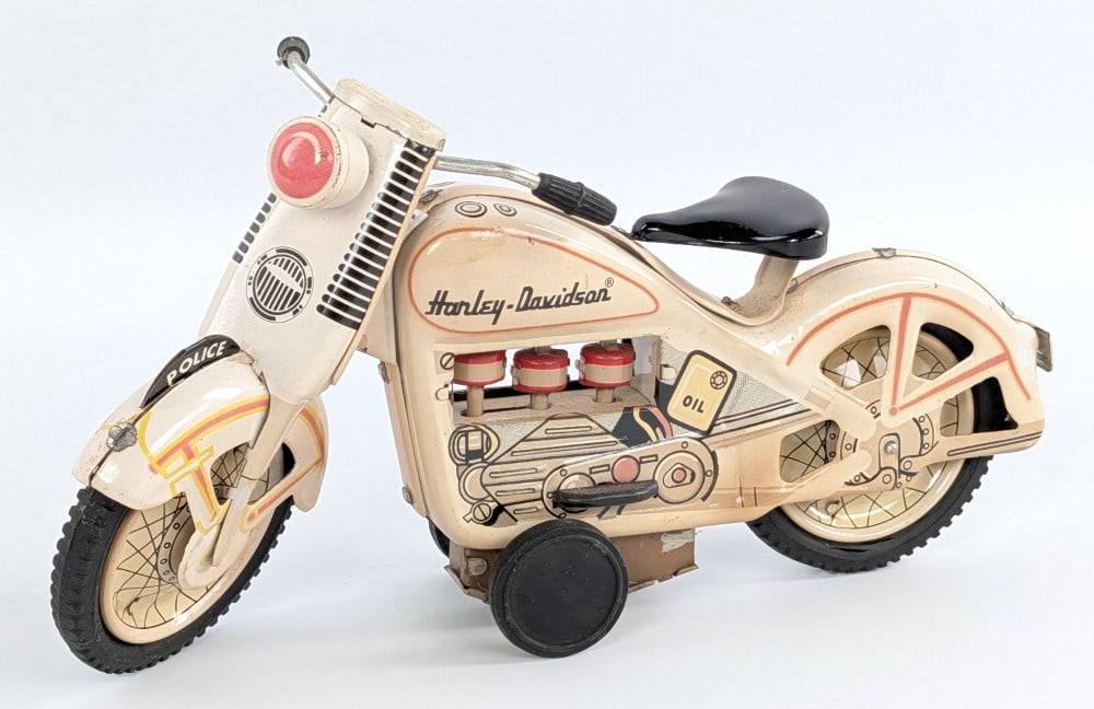 Japan Tin Friction Harley-Davidson Police Motorcycle: Japan tin friction Harley-Davidson Police motorcycle. The friction works and the pistons move as they should. Has a couple small scratches and some tiny touchup's. Measures approximately 9-1/4" long.