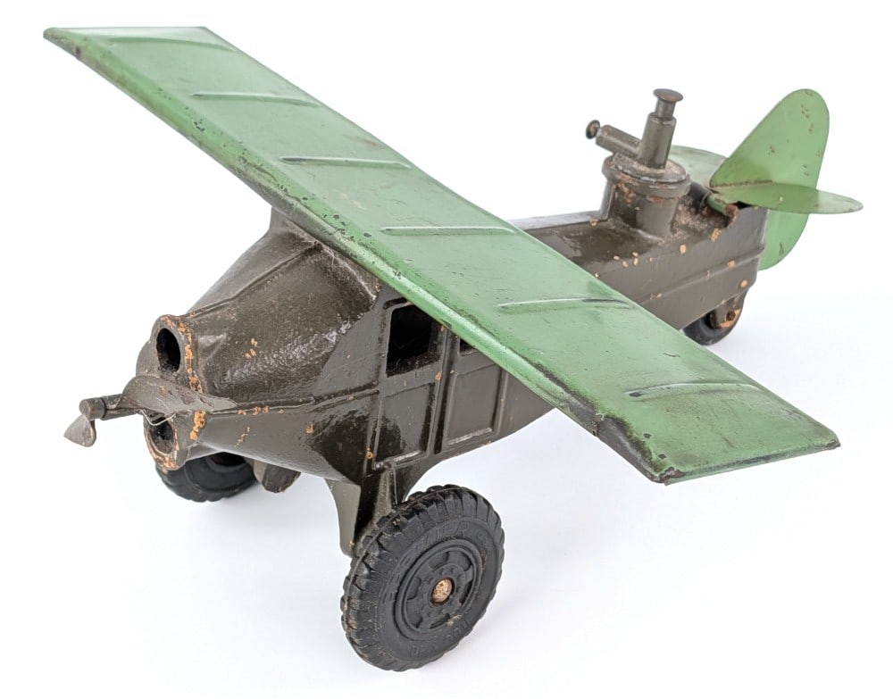 Big-Bang Bombing Airplane: Big-Bang bombing airplane. The plane is cast iron with pressed steel wings and propellor. Original condition with paint loss and wear from use and age. Wingspan measures approximately 13" long.