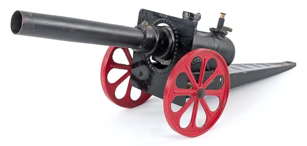 Big-Bang Toy Cannon: Big-Bang toy cannon. Constructed of cast iron with pressed steel parts. Shows some paint loss, minor surface rust, and wear from use and age. Measures approximately 24" long.