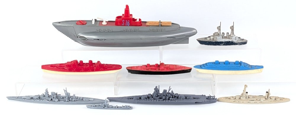 (9) Toy Battleships: (9) Toy battleships. Includes plastic and metal ships. Some more intricate than others. Varying in age and condition. The largest ship has some minor damage to one of the plastic edge pieces. Largest 