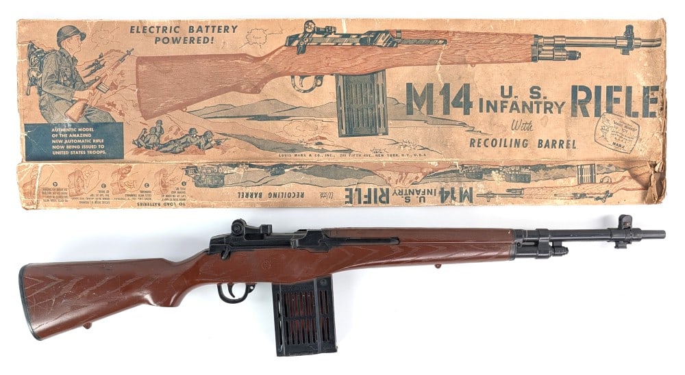 Marx Battery Powered M14 U.S. Infantry Rifle with Recoiling Barrel in Box: Marx battery powered M14 U.S. Infantry Rifle with recoiling barrel and the original box. The rifle shows some scuff marks and scratches from play and age. The box is missing all of the end flaps and s