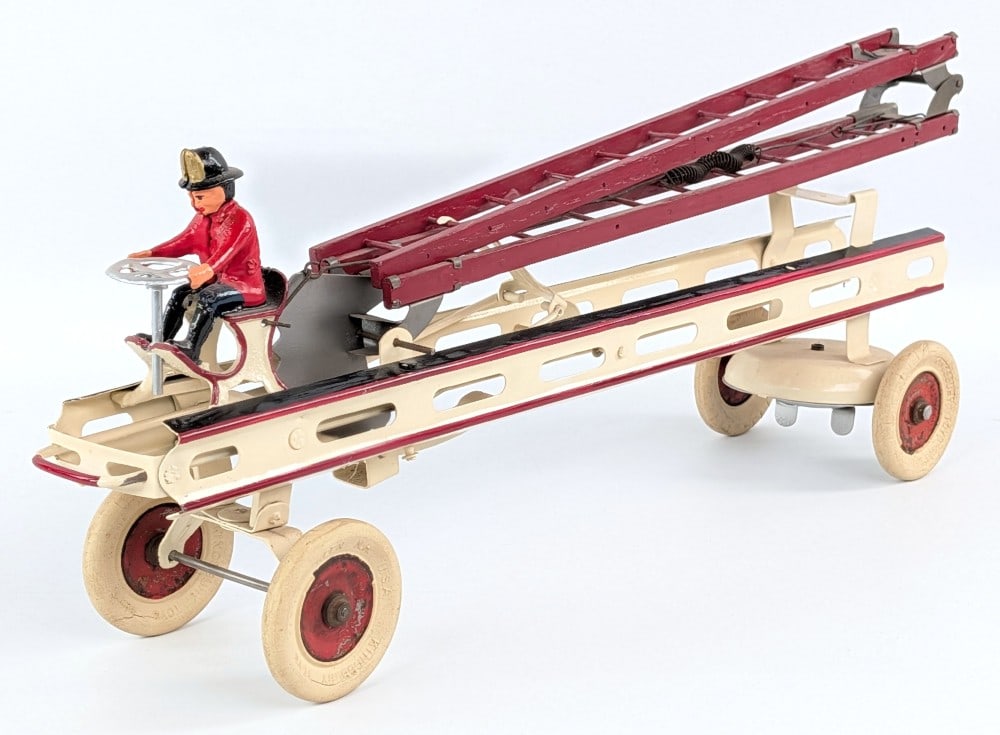 Restored Kingsbury Toys Aerial Ladder Fire Truck: Restored Kingsbury toys aerial ladder fire truck. The truck has a rear windup mechanism and when the front bumper is hit the ladder extends and shoots up. Working condition. Average restoration that d